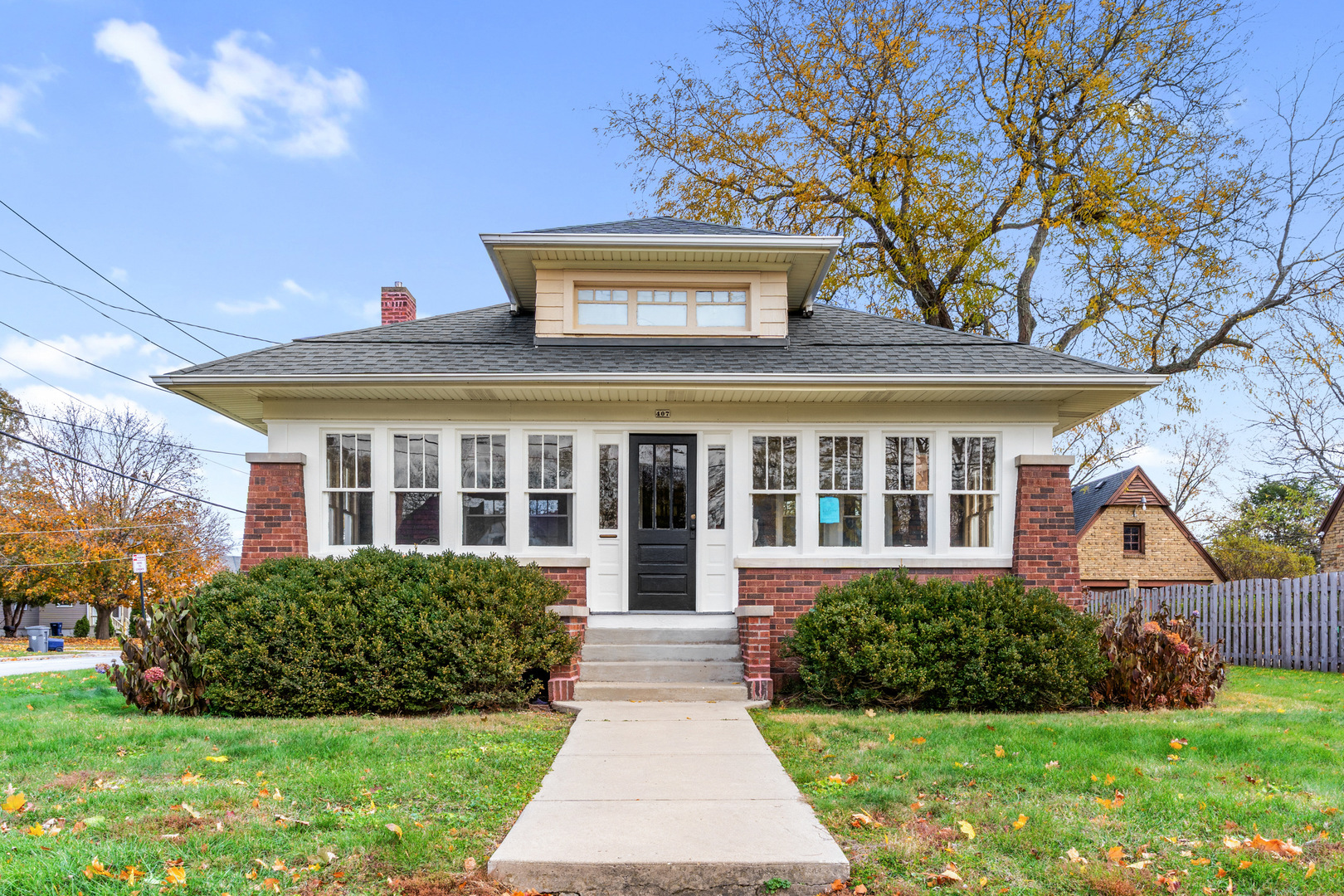 407 North Liberty Street Elgin, IL 60120 - Photo 2 of 18 a front view of a house with a yard and potted plants