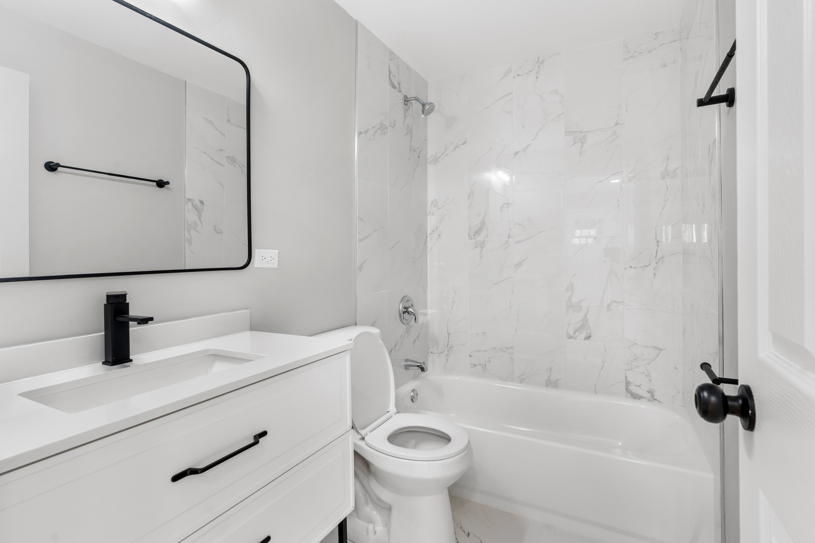 407 North Liberty Street Elgin, IL 60120 - Photo 9 of 18 a bathroom with a sink a toilet and a mirror