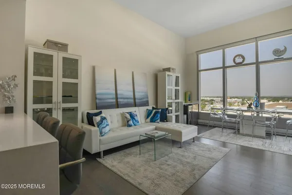 a living room with furniture and large windows