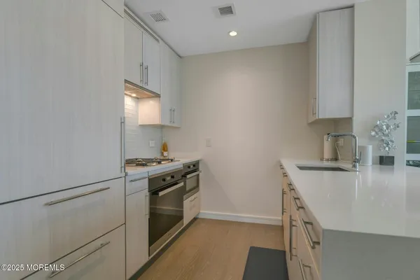a kitchen with a stove and a sink