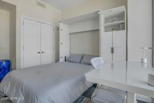 a bedroom with a large bed and a large window