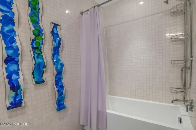 a bedroom with a bed and large window