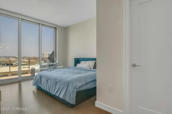 a spacious bedroom with a large bed and a large window
