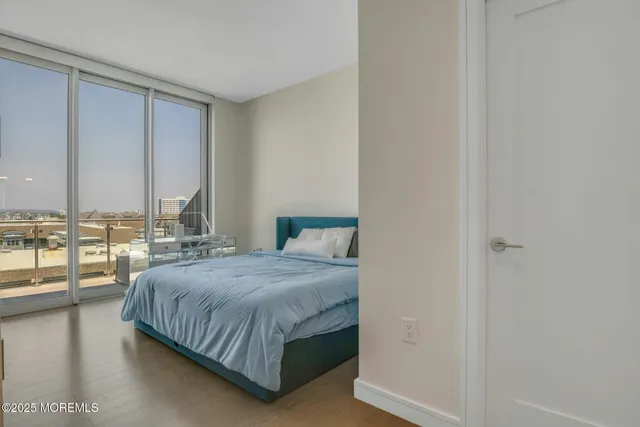 a spacious bedroom with a large bed and a large window