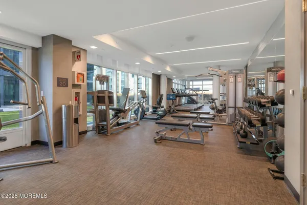 a living room with furniture a fireplace and a kitchen view