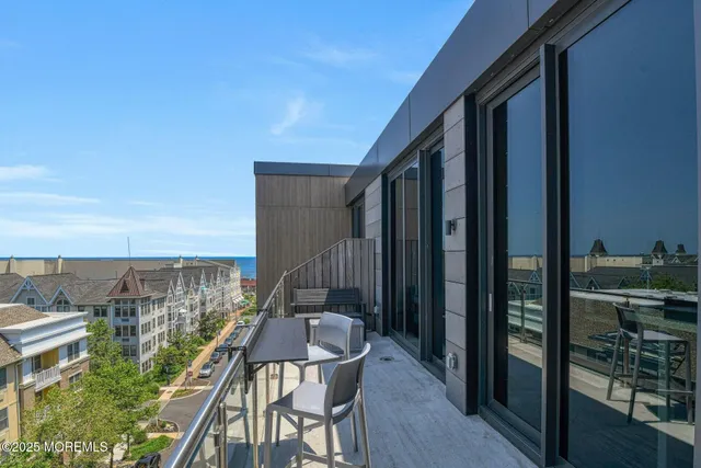 a balcony with table and chairs