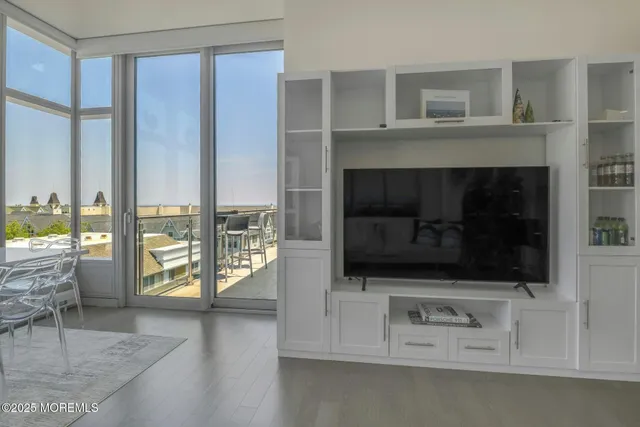 a living room with a flat tv screen and a fireplace
