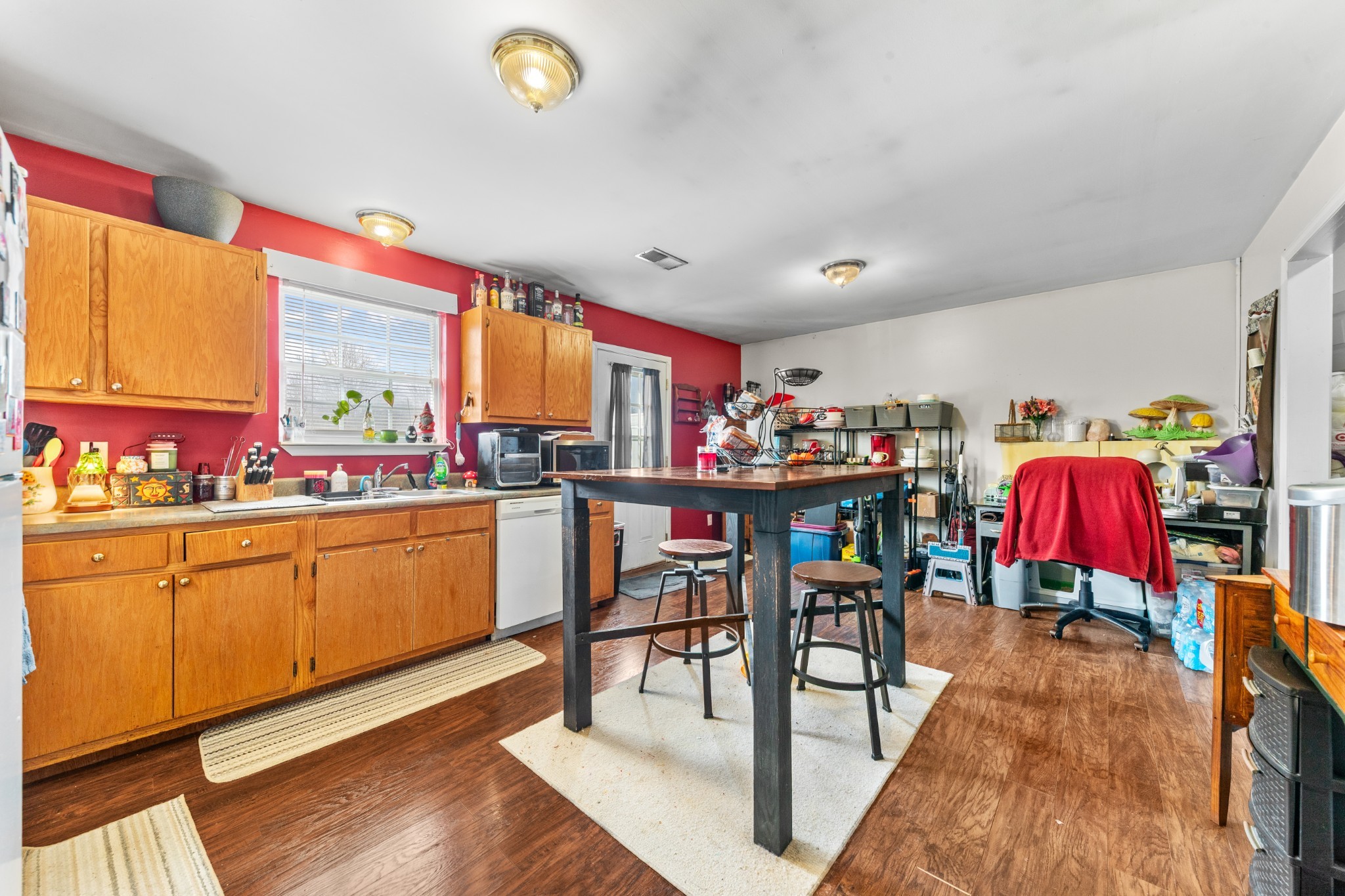 1916 Word Road Lewisburg, TN 37091 - Photo 23 of 69 a kitchen with stainless steel appliances kitchen island granite countertop a table chairs in it and wooden floors