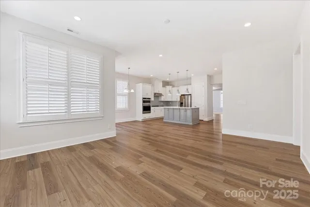 a view of kitchen view wooden floor and window
