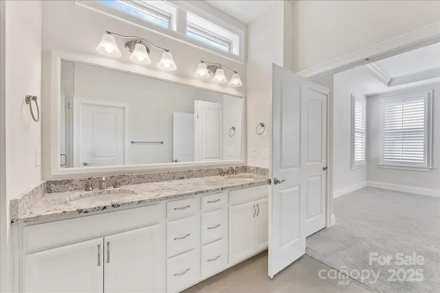 a bathroom with a granite countertop sink a large mirror and a