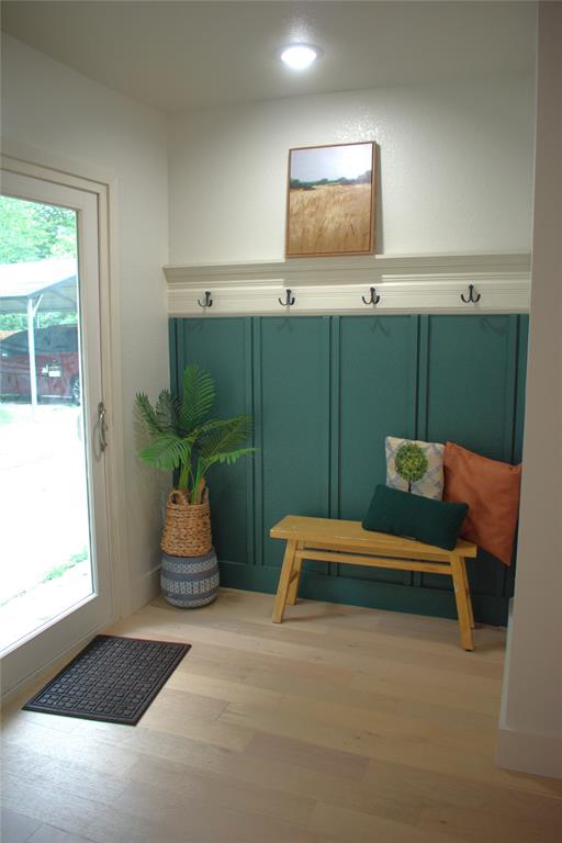 2908 Washington Street Commerce, TX 75428 - Photo 20 of 40 Entryway featuring light wood-finish flooring, recessed lighting, and a built-in board and batten wall with four coat hooks