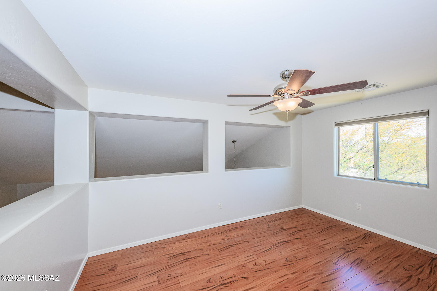 728 South Porter Routh Place Vail, AZ 85641 - Photo 18 of 36 a view of a room with wooden floor and fan