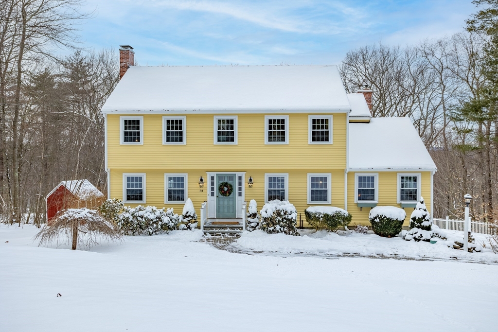 84 Vaughn Hill Road Bolton, MA 01740 - Photo 1 of 40 a front view of house with yard outdoor seating and barbeque oven