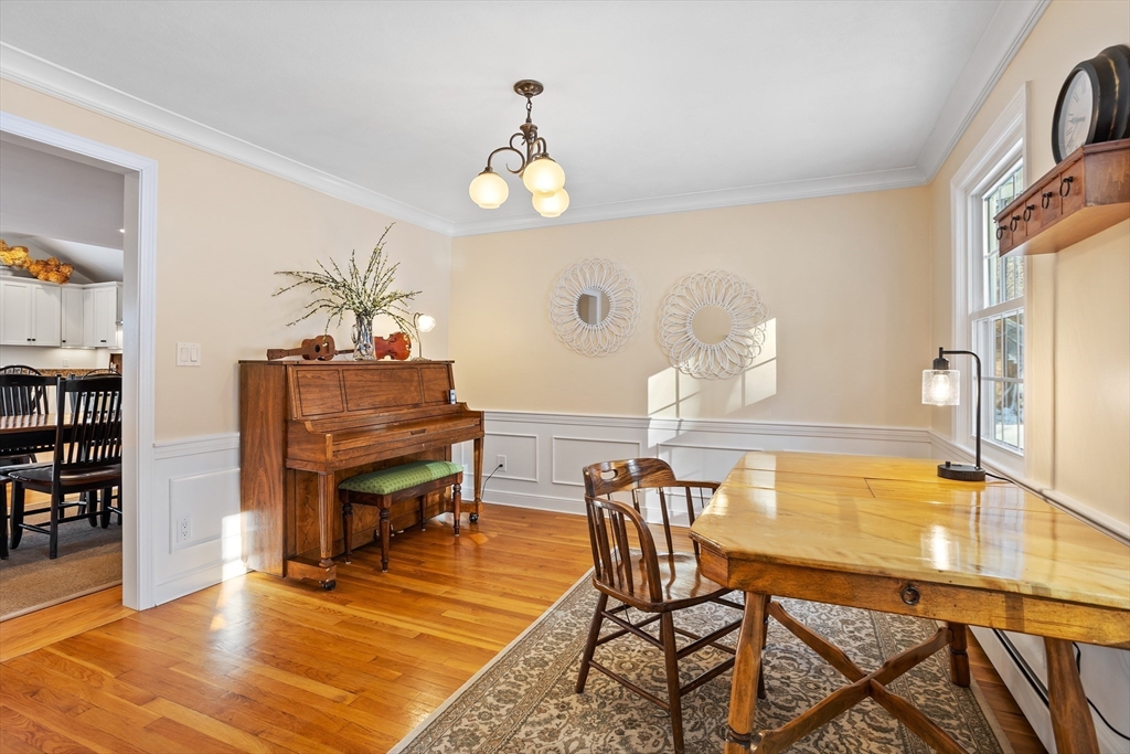 84 Vaughn Hill Road Bolton, MA 01740 - Photo 13 of 40 a dining room with furniture a rug and wooden floor