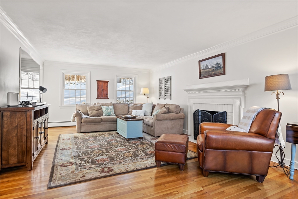84 Vaughn Hill Road Bolton, MA 01740 - Photo 15 of 40 a living room with furniture fireplace and a table