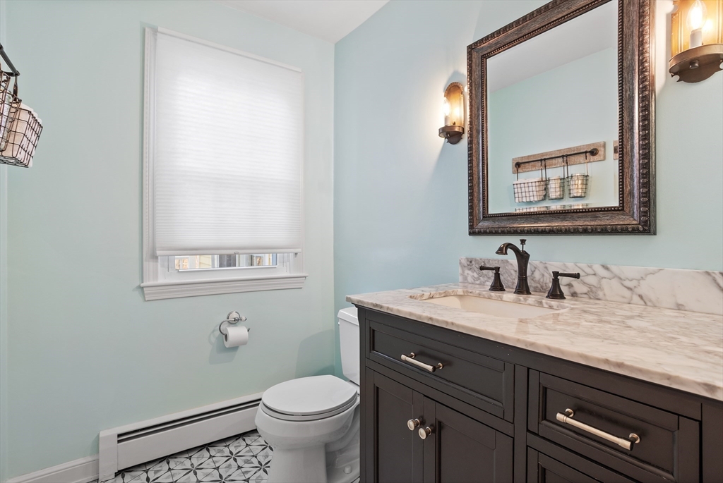 84 Vaughn Hill Road Bolton, MA 01740 - Photo 18 of 40 a bathroom with a granite countertop toilet sink and mirror