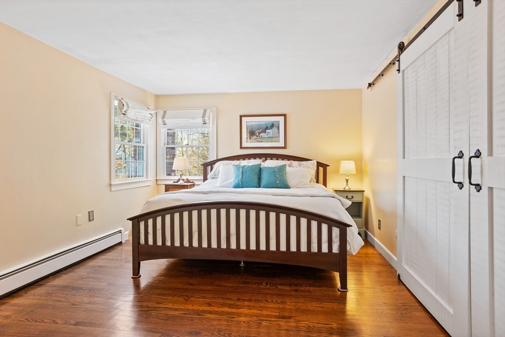 84 Vaughn Hill Road Bolton, MA 01740 - Photo 19 of 40 a bedroom with a bed and wooden floor