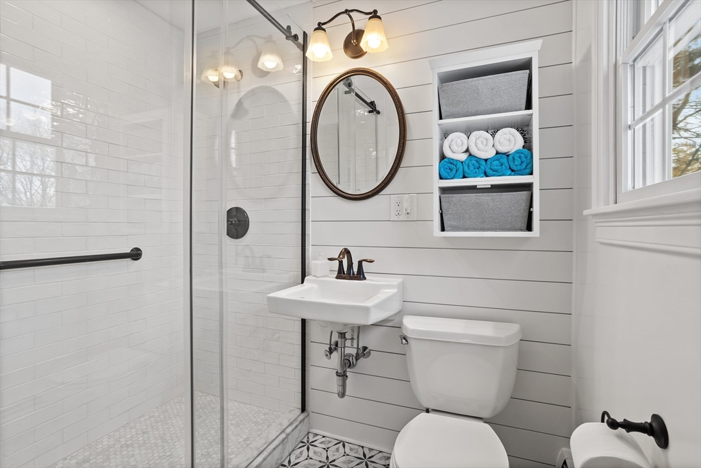 84 Vaughn Hill Road Bolton, MA 01740 - Photo 21 of 40 a bathroom with a toilet a sink and mirror