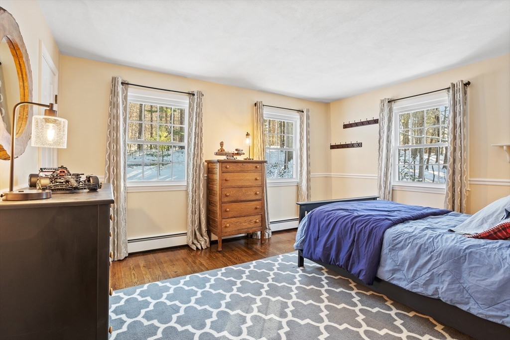 84 Vaughn Hill Road Bolton, MA 01740 - Photo 22 of 40 a bedroom with a bed and a window