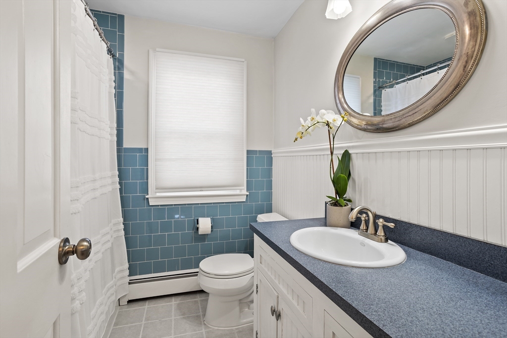 84 Vaughn Hill Road Bolton, MA 01740 - Photo 25 of 40 a bathroom with a sink a toilet and a mirror