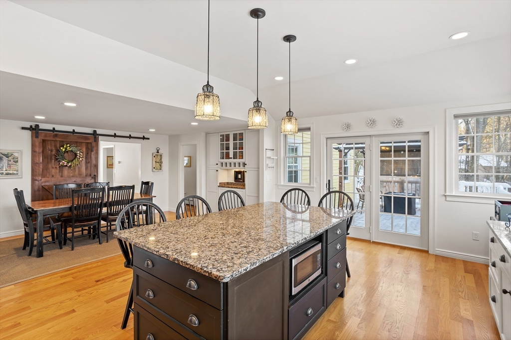 84 Vaughn Hill Road Bolton, MA 01740 - Photo 4 of 40 a kitchen with granite countertop a table chairs stove and kitchen view
