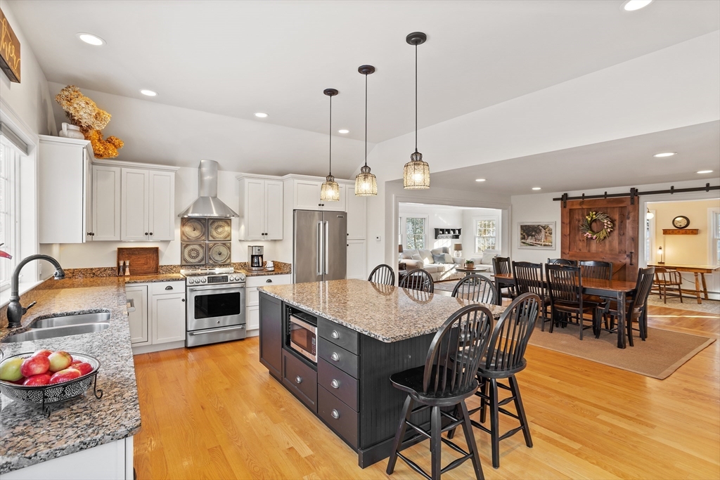 84 Vaughn Hill Road Bolton, MA 01740 - Photo 6 of 40 a large kitchen with a table and chairs