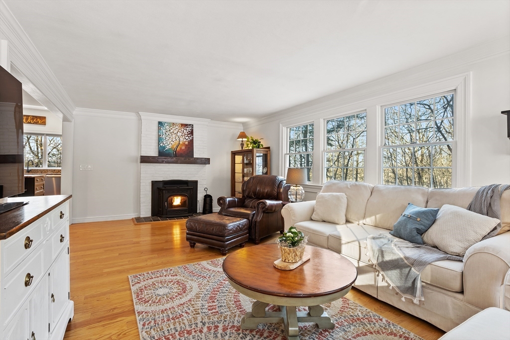 84 Vaughn Hill Road Bolton, MA 01740 - Photo 9 of 40 a living room with furniture a fireplace and a window