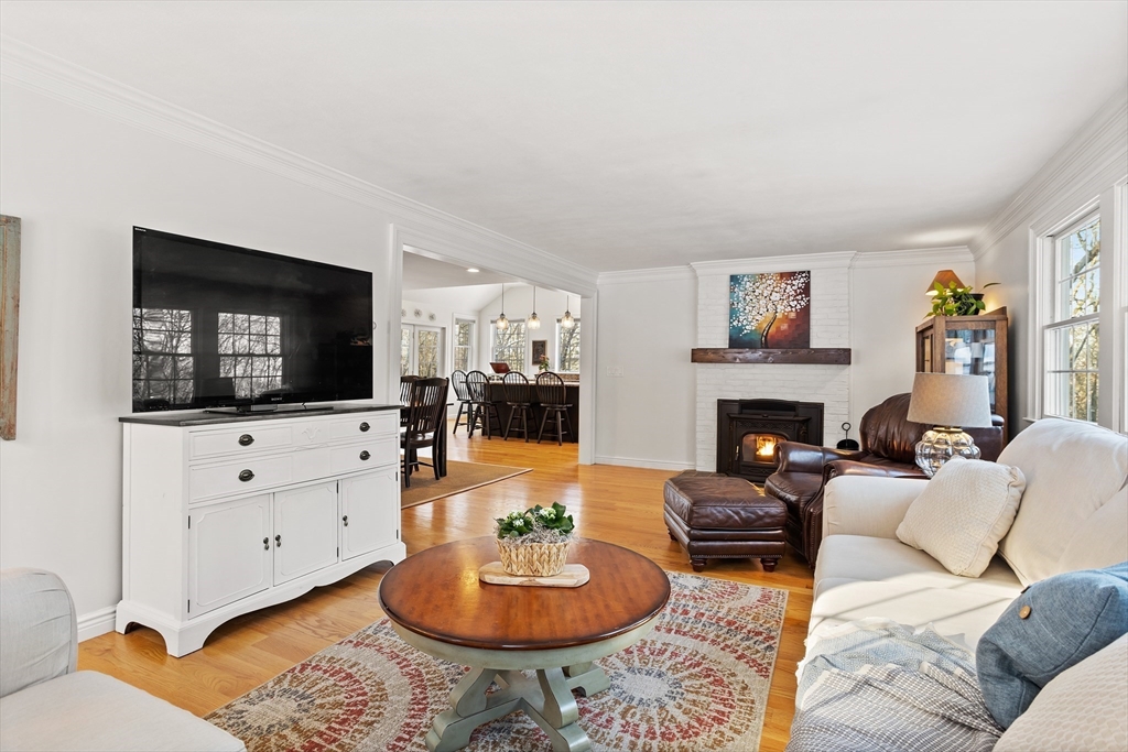 84 Vaughn Hill Road Bolton, MA 01740 - Photo 10 of 40 a living room with furniture a flat screen tv and a fireplace