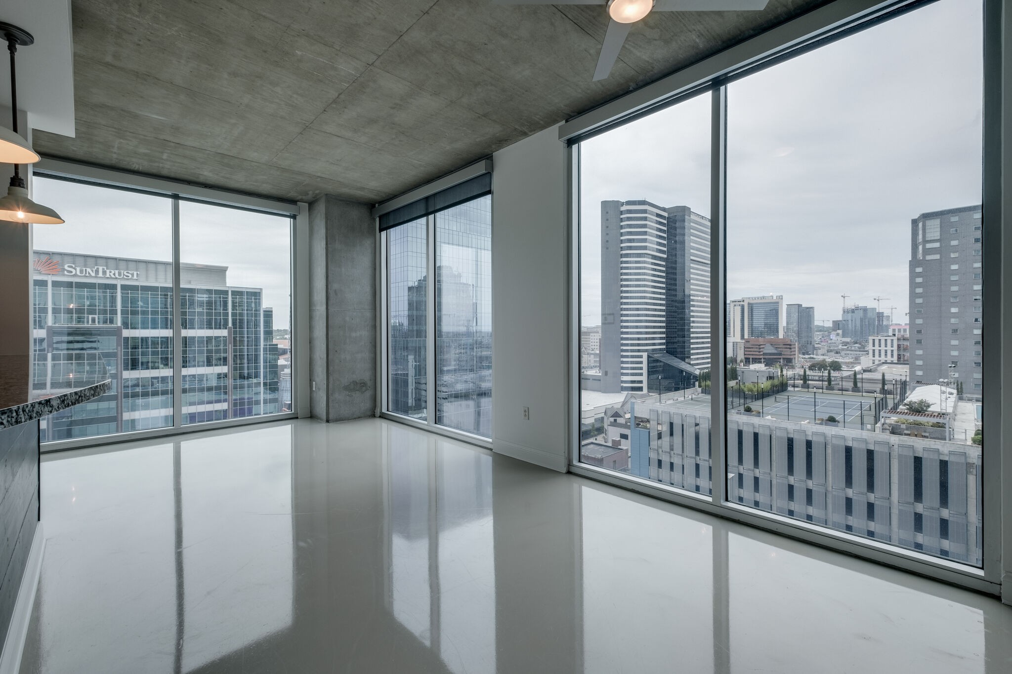 a view of a city from a balcony with furniture
