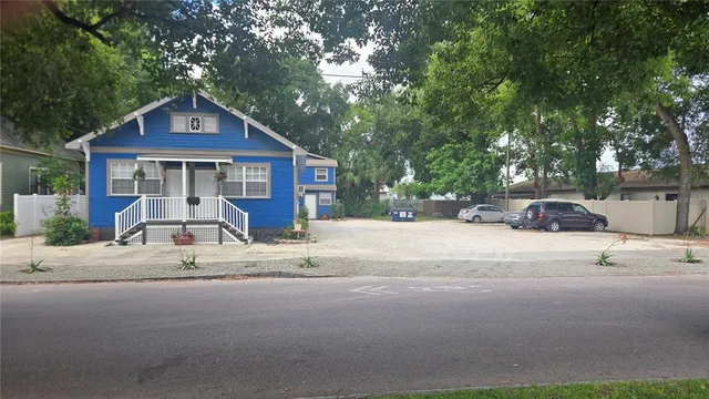 a view of a house with a yard next to a road