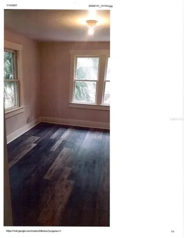 a view of hallway with wooden floor