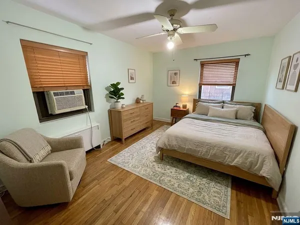 a spacious bedroom with a bed a couch and dresser