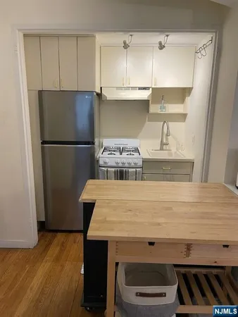 a kitchen with a refrigerator and a stove