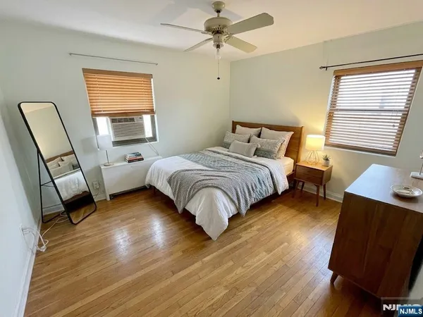 a bedroom with a bed window and a chair