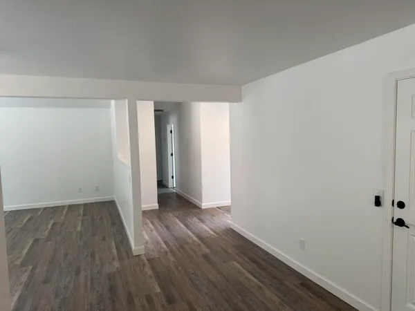 a house view with wooden floor and a ceiling fan