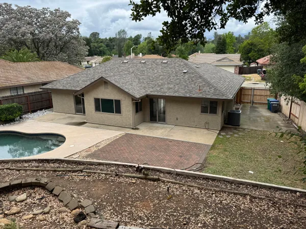 an aerial view of a house with a yard