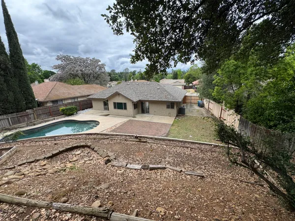 a house with swimming pool in front of it