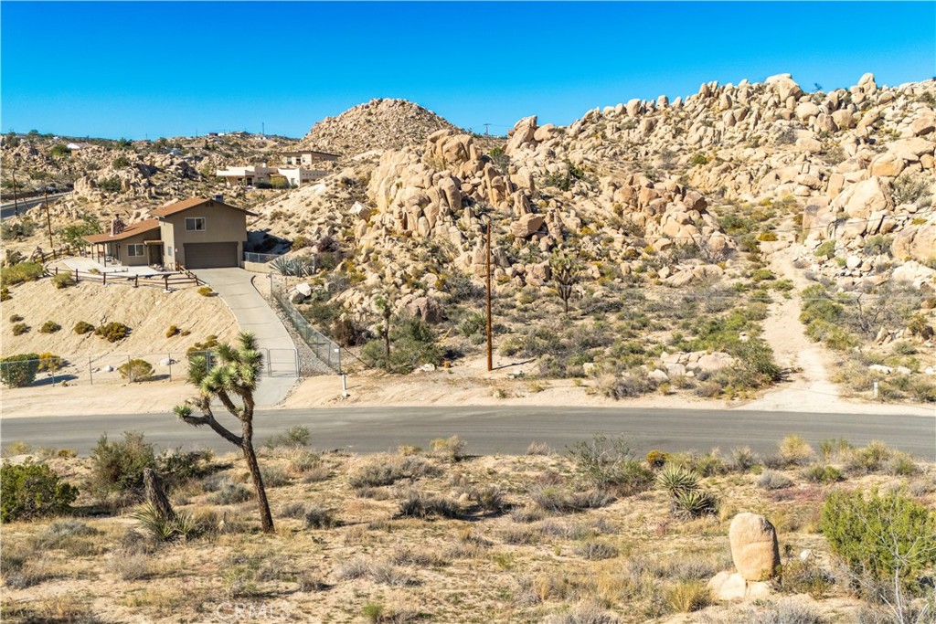 0 San Juan Road Yucca Valley, CA 92284 - Photo 15 of 24 a view of a large building with a mountain view in back