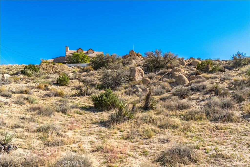 0 San Juan Road Yucca Valley, CA 92284 - Photo 18 of 24 a view of a large building with trees in the background