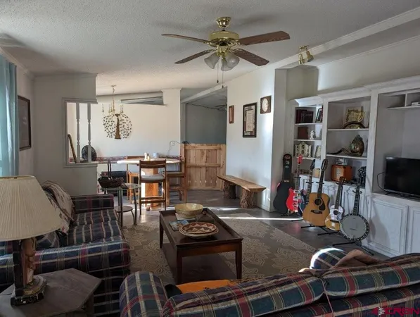 a room with gym equipment and a view of living room