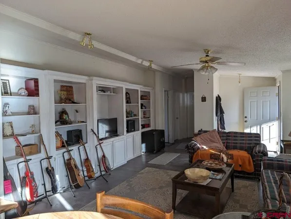 a living room with furniture and a book shelf