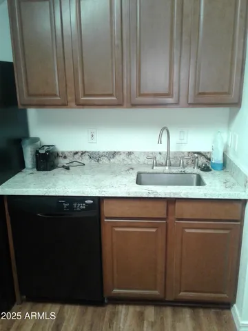 a kitchen with stainless steel appliances granite countertop a sink and a stove