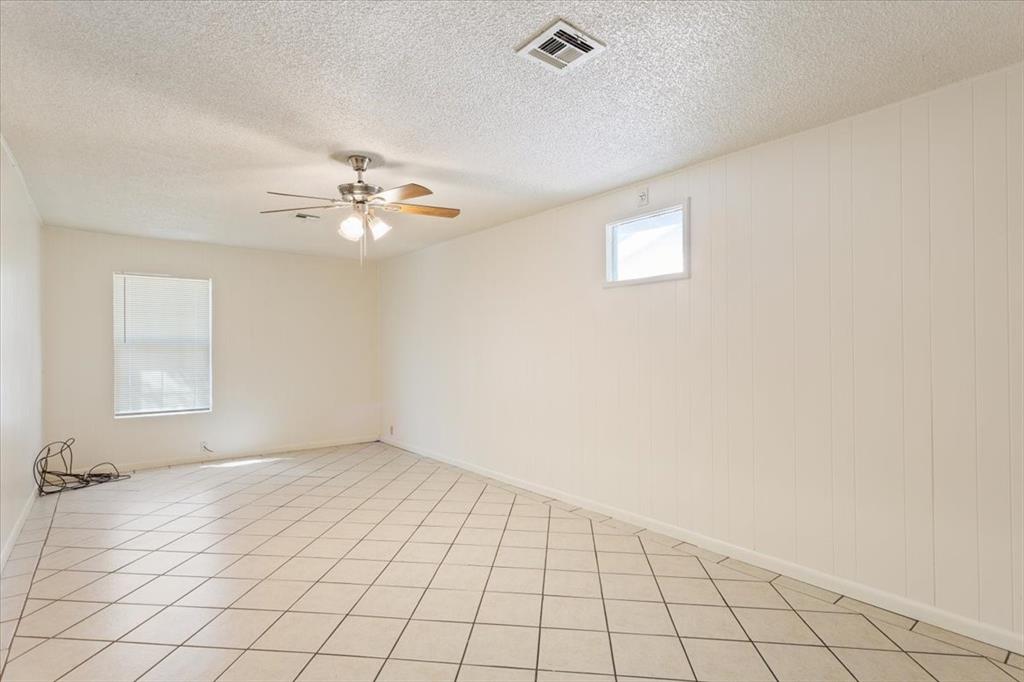 2424 South 26th Street Waco, TX 76706 - Photo 13 of 25 an empty room with windows and fan