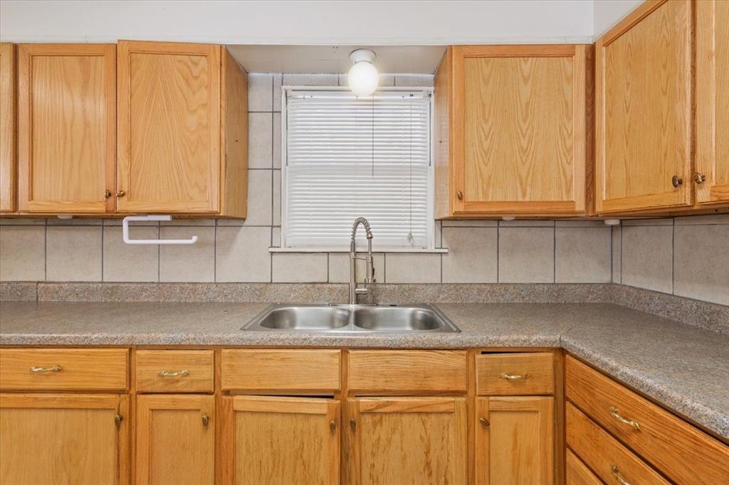 2424 South 26th Street Waco, TX 76706 - Photo 10 of 25 a kitchen with stainless steel appliances granite countertop white cabinets sink and dishwasher