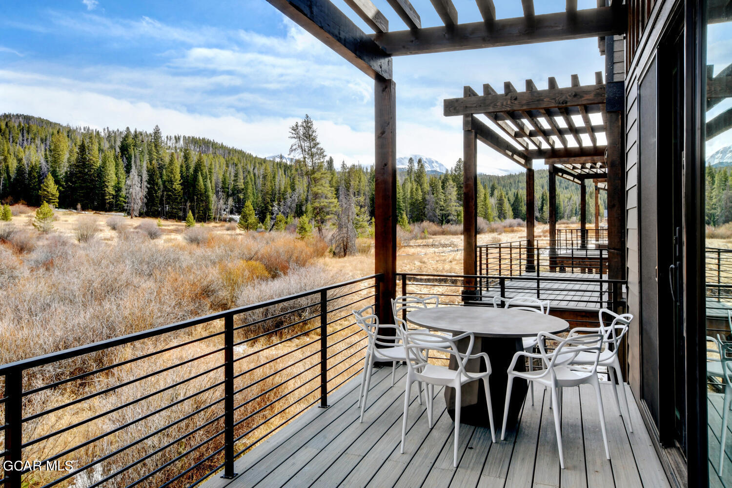 Undisclosed Address Winter Park, CO 80482 - Photo 38 of 52 a view of a balcony with a dining table and chairs with wooden floor