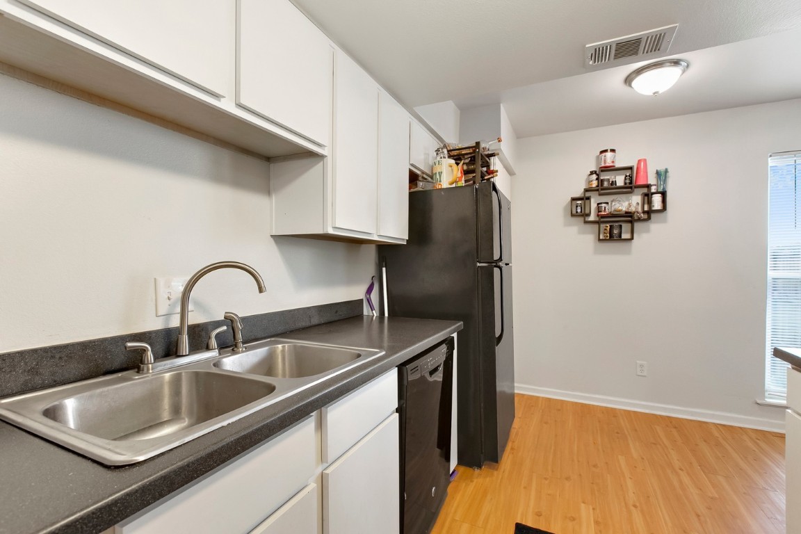 a kitchen with a sink and refrigerator
