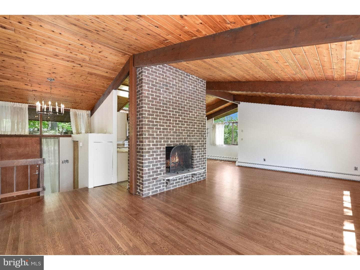 731 Limehouse Road Wayne, PA 19087 - Photo 3 of 25 a view of empty room with wooden floor and fireplace