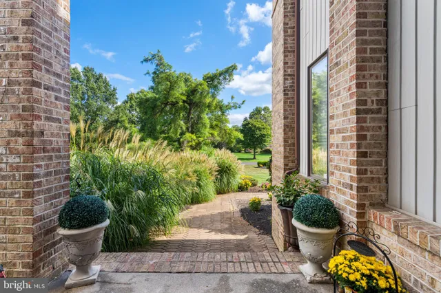 a view of a dining room with furniture a chandelier and wooden floor