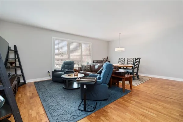 a living room with furniture a rug and a window
