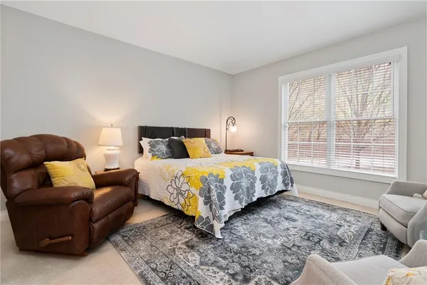 a bedroom with a bed couch and window